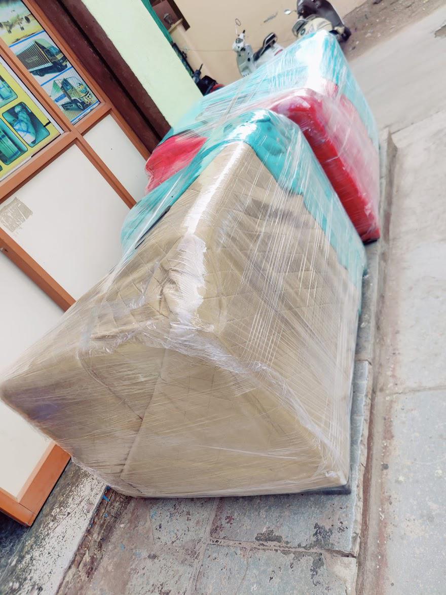 Sofa professionally wrapped with quilt and stretch film for safe move