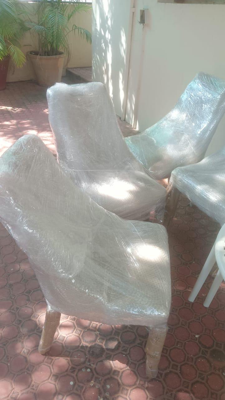Sofa set wrapped in bubble wrap and stretch film at warehouse