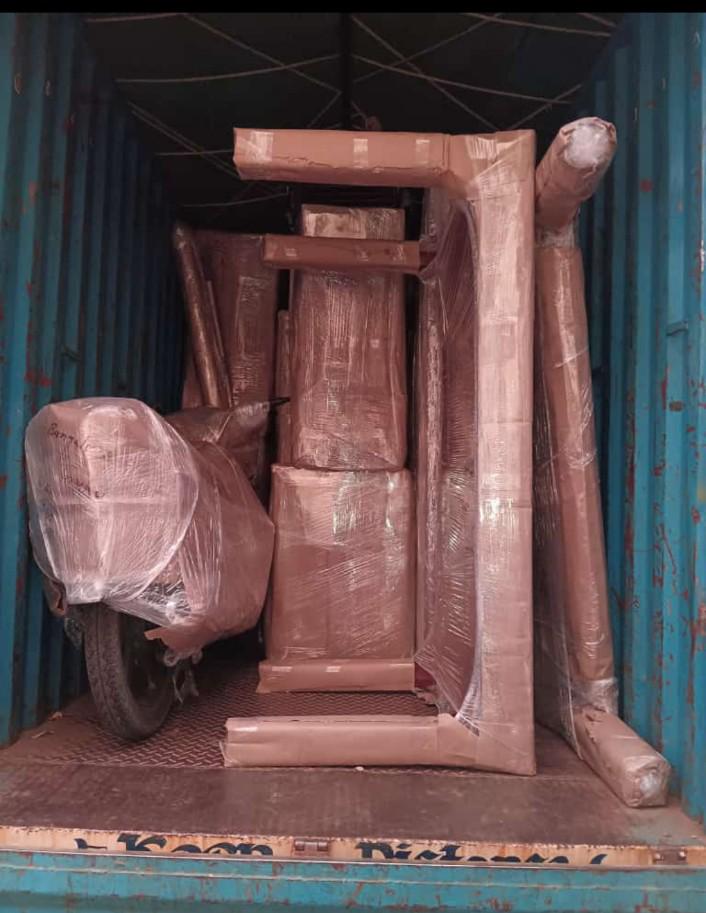 Bike and furniture loaded inside container truck for transport