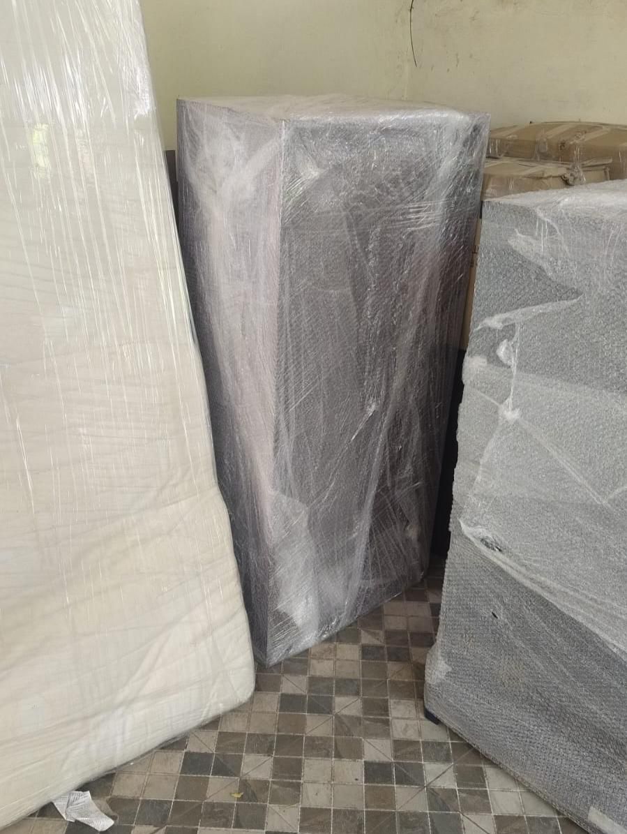 Bubble-wrapped large furniture stored safely in warehouse