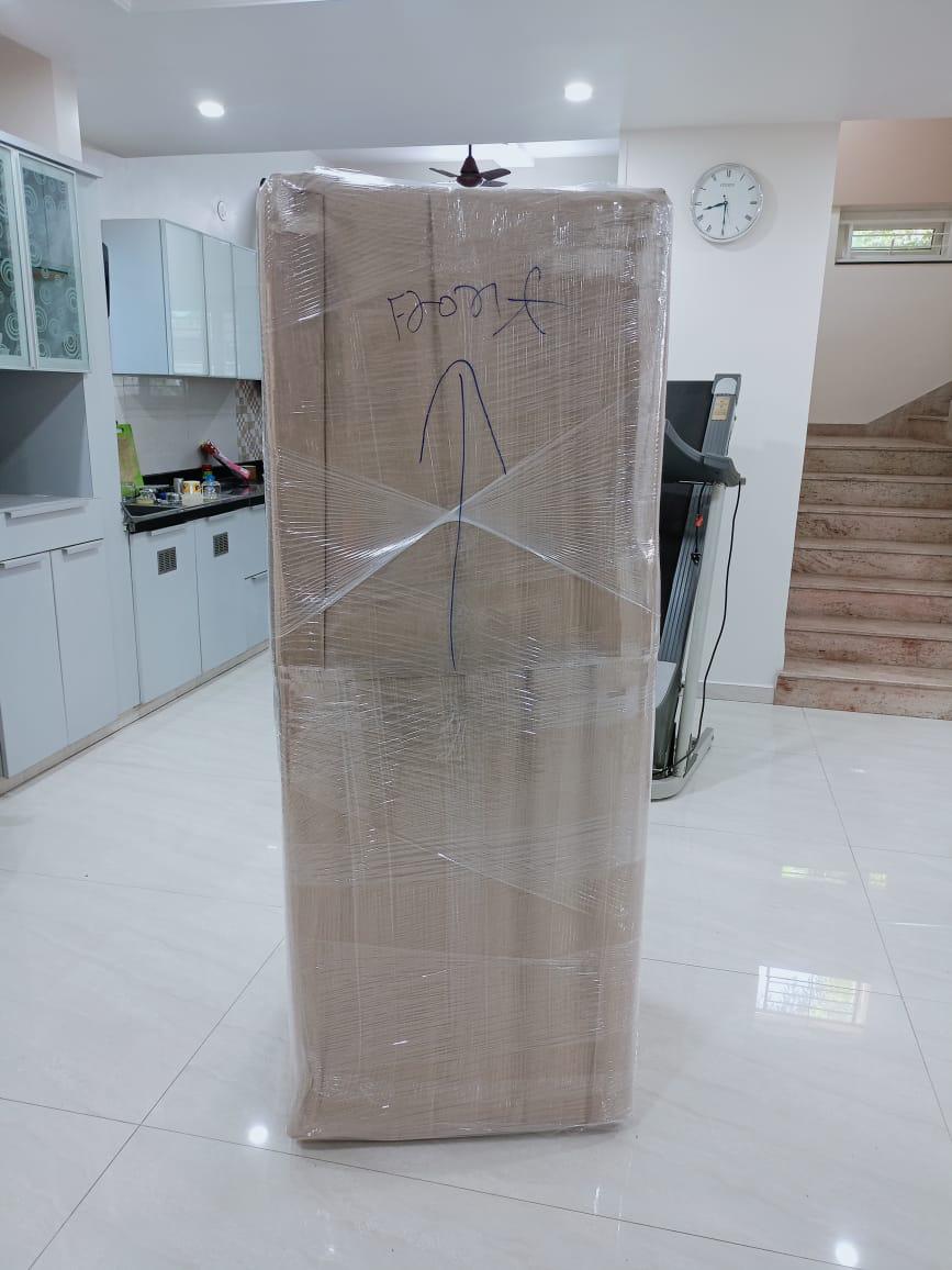 Large home appliance wrapped in stretch film during shifting service