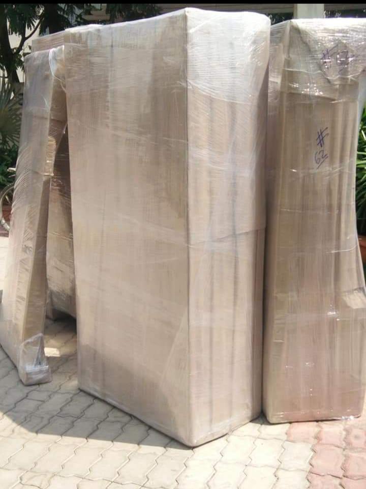 Plastic chairs bubble-wrapped for safe transport during home shifting