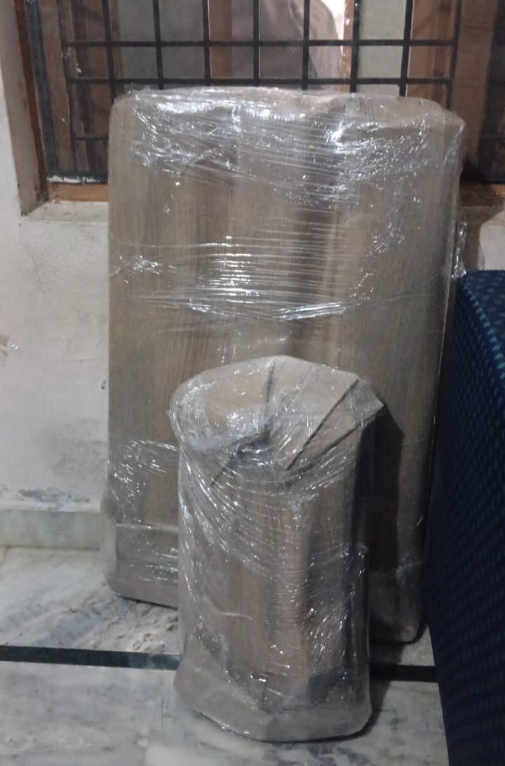 Wrapped sofa and ottoman packed with stretch film for relocation