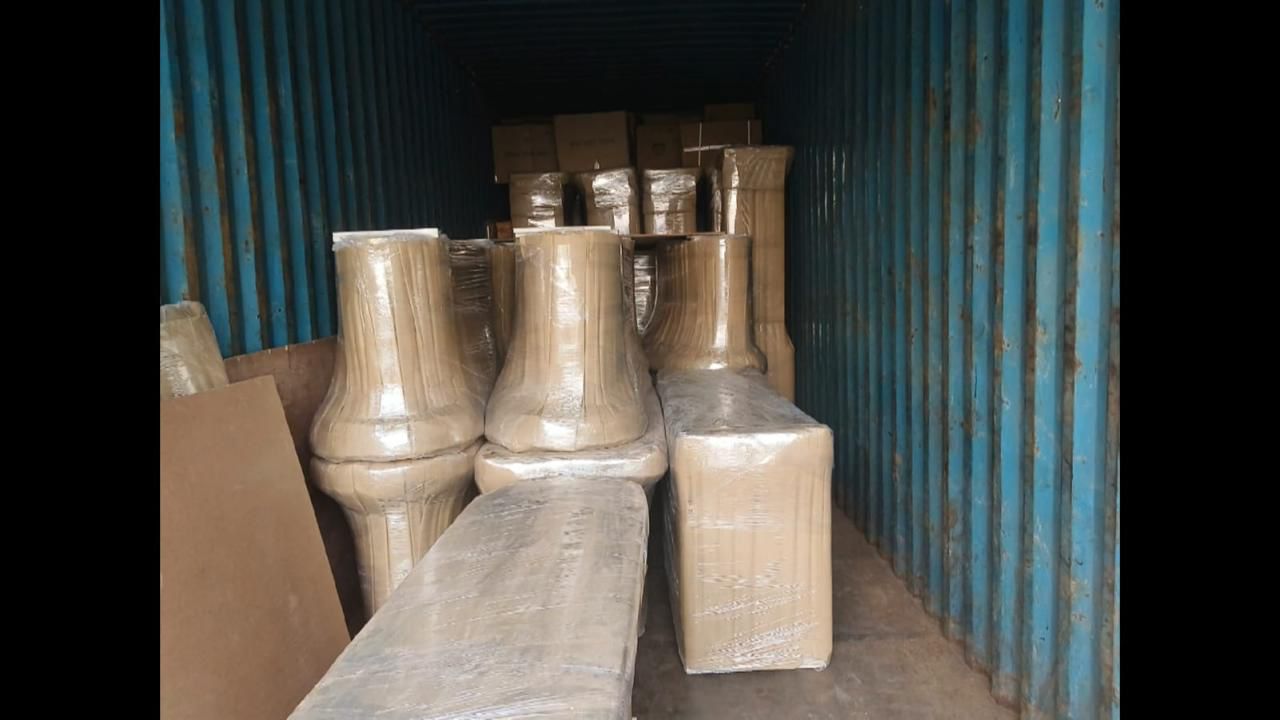 Container fully loaded with packed wooden furniture for long-distance move