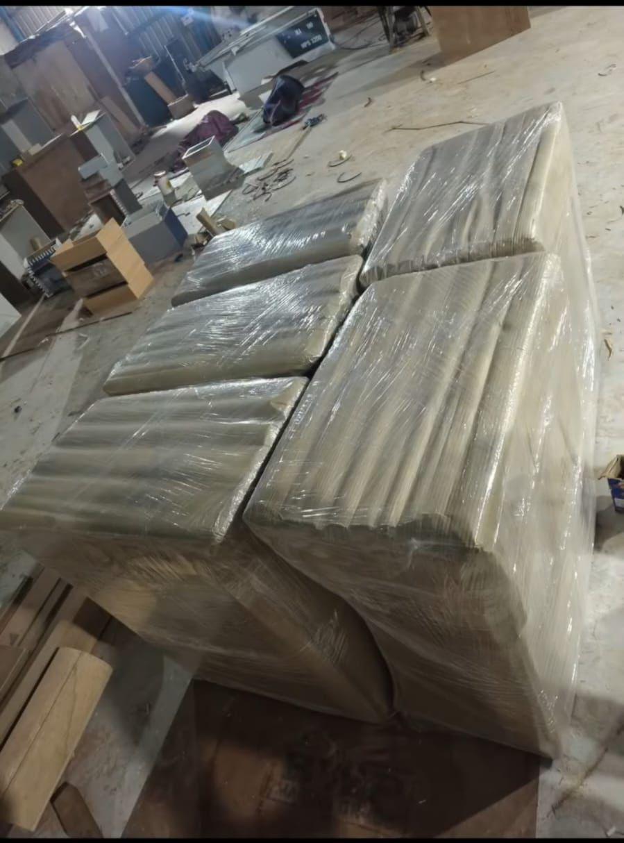 Multiple mattresses wrapped in stretch film at packing warehouse