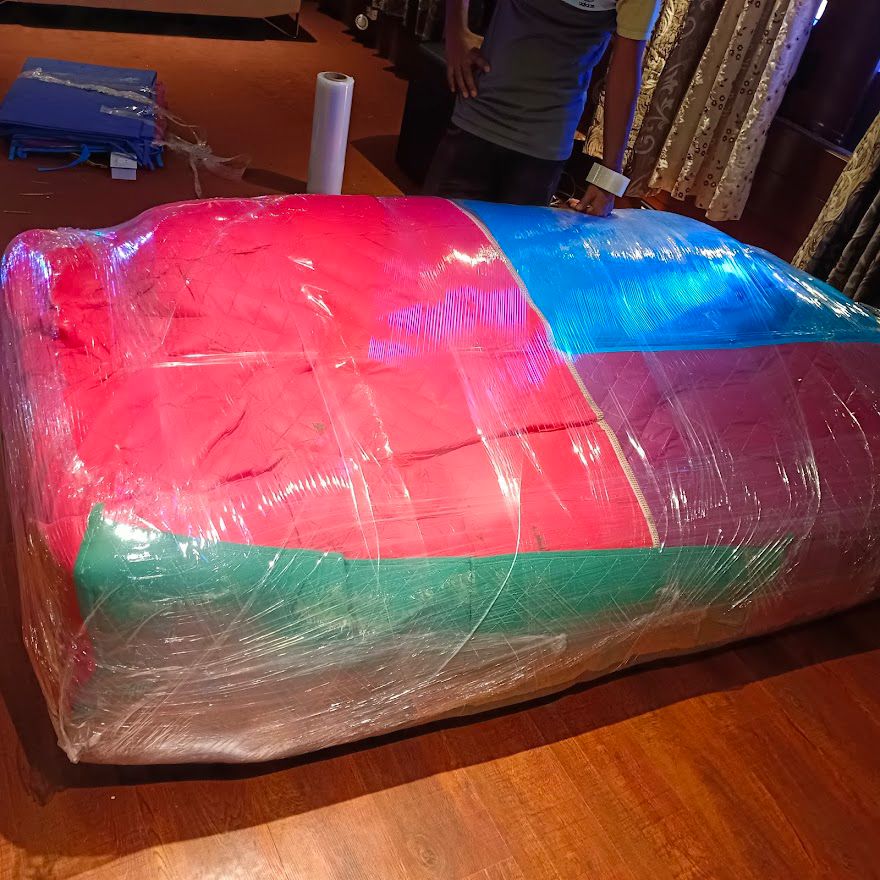 Sofa professionally wrapped with quilt and stretch film for safe move
