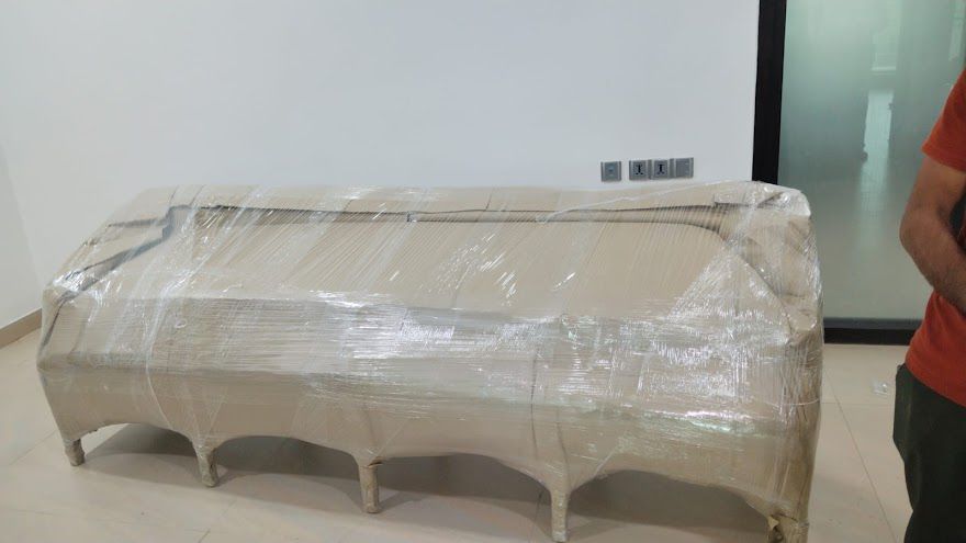 Large sofa fully wrapped and packed for relocation