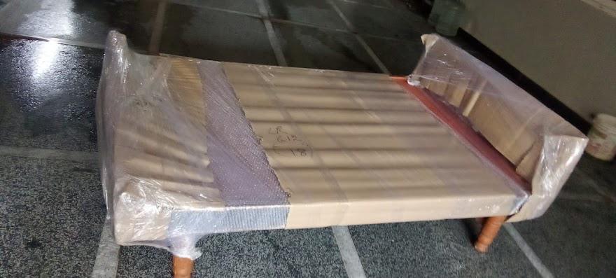 Wooden cot packed with corrugated sheet and stretch wrap